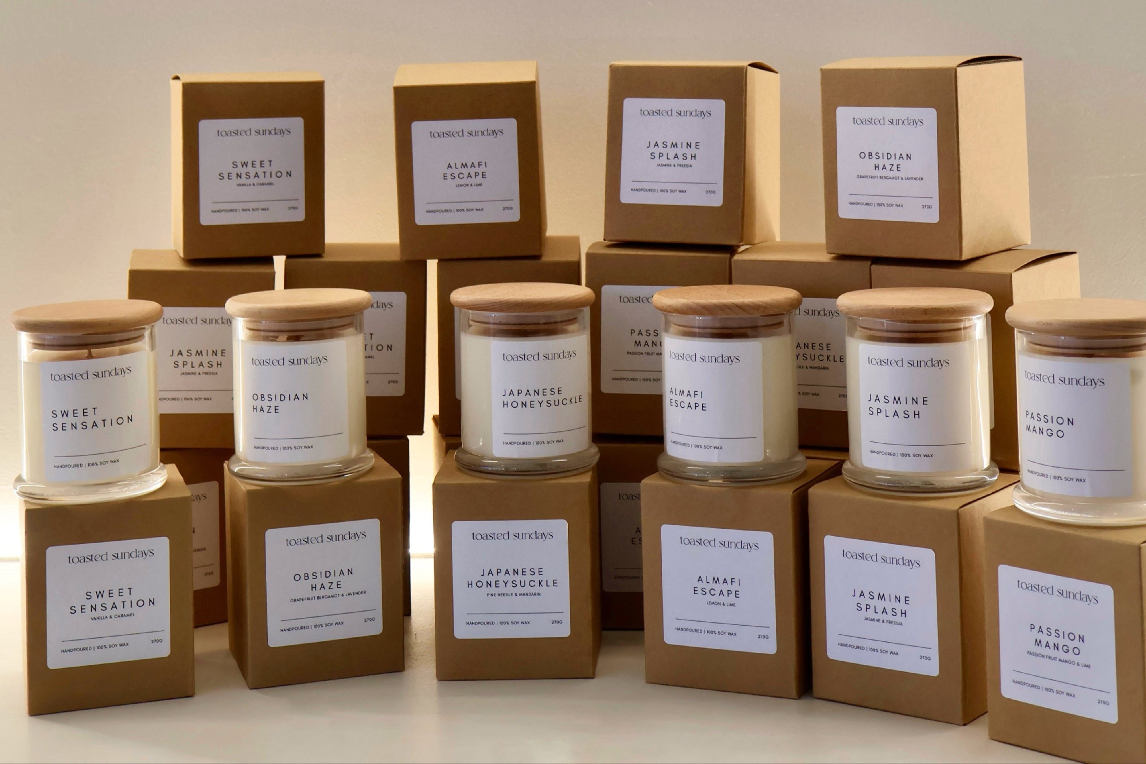 Collection of candles and boxes with labels on a neutral background
